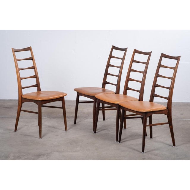 Elegant set of 4 'Lis' dining chairs designed by Niels Koefoed in beautifully grained rosewood. A slim, refined, and...