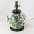 This antique table lamp is crafted from an authentic white porcelain vase featuring a vibrant Famille Rose botanical scene...
