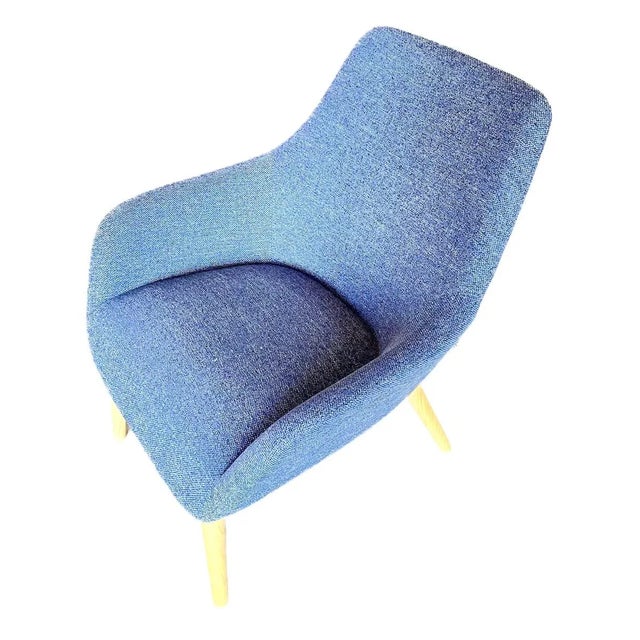 Vintage Mid-Century Modern style blue texture upholstered chair with tapered legs. Marked "B & J Design" on a tag at the...