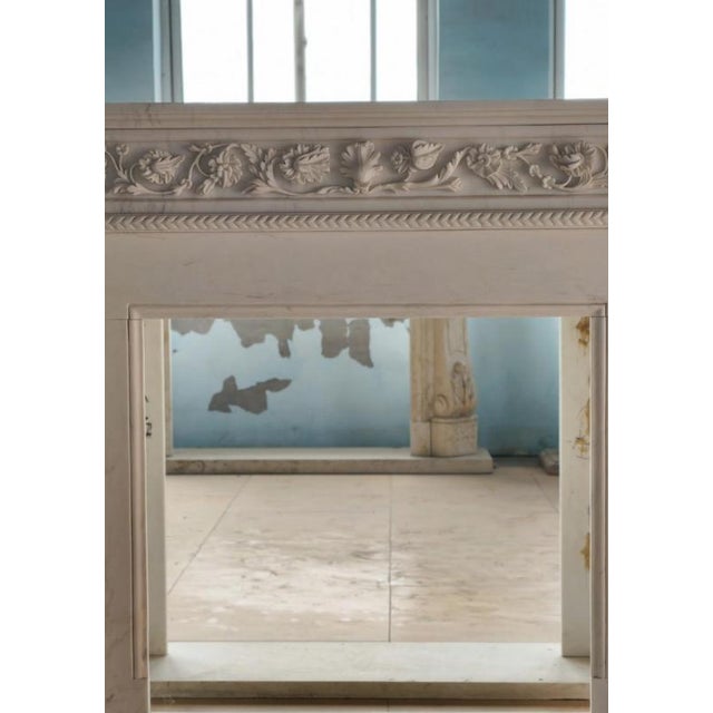 This stately neoclassical marble fireplace mantle offers a beautiful balance of symmetry, ornament, and proportion. The...