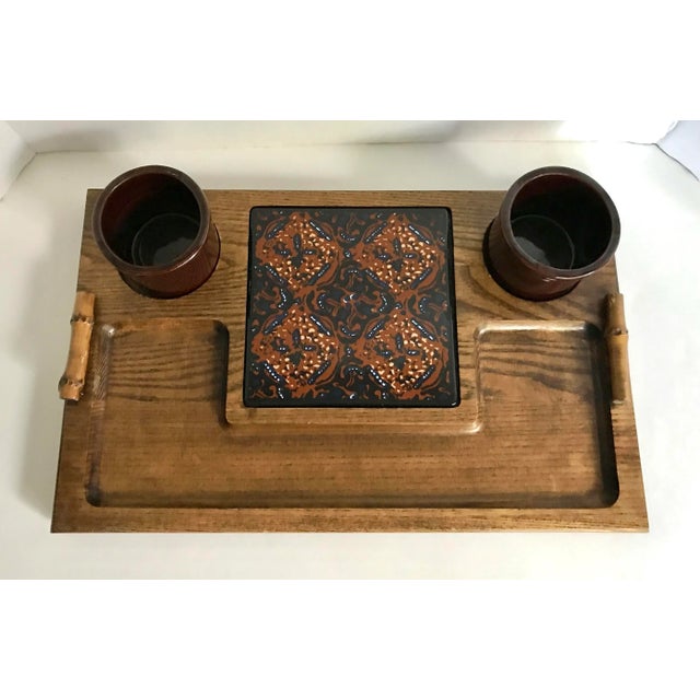 This is a wonderful piece from the mid-century that is perfect for entertaining! There is a tile for cutting, plenty of...