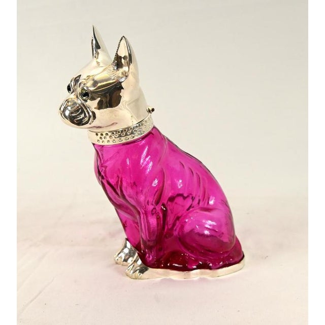 Unusual novelty glass and silver plate decanter modelled as a seated dog Vibrant pink glass body with fluid, sculptural...