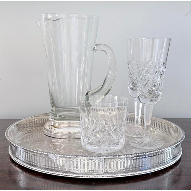 Elegant silverplate tray with button feet and graceful reticulated gallery and an intricately engraved base. Marked...