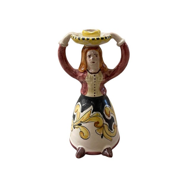 This charming vintage Italian ceramic candlestick showcases the vibrant artistry of traditional majolica pottery....