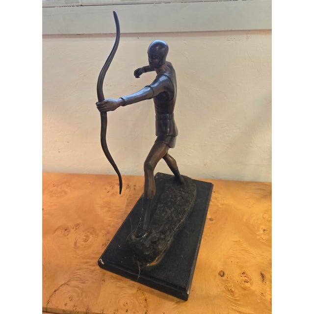 Beautiful bronze sculpture of an archer pulling on an arrow sits on a marble base. great Deco style. Our purpose at 50s...