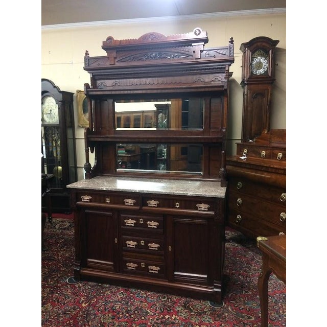 Item: Antique Walnut Buffet with Marble Top and Mirrored Backsplash. Age & Condition: Circa 1880. Refinished and restored,...