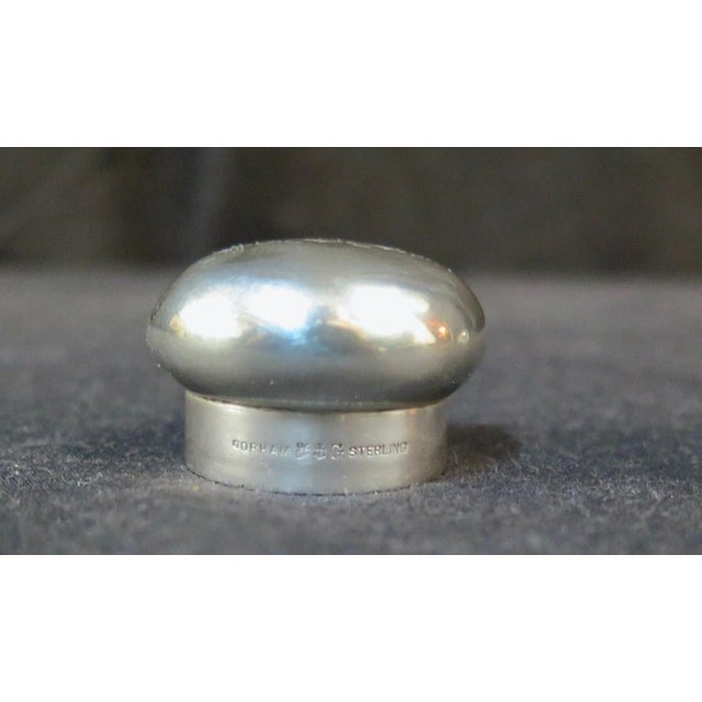 This vintage 19th century American perfume/cologne bottle is designed in crystal & accented with a sterling silver top....