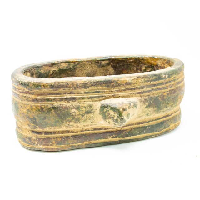 Offering a set of three terracotta lion head planters. Elongated oval planters in graduated sizes from large too small. On...