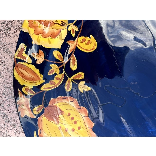 Stunning plate in deep blue with golden leaves. Measures 12 inches in diameter great for serving appetizers, hors...