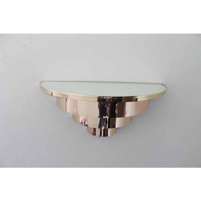 Unique and glamorous mirrored wall mounted demilune console table. Measurements: 24" Width 10" Height 12" Depth Condition:...
