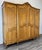 This refined Vintage French Louis style wardrobe presents elegant carved panel doors, a gently shaped cornice with...