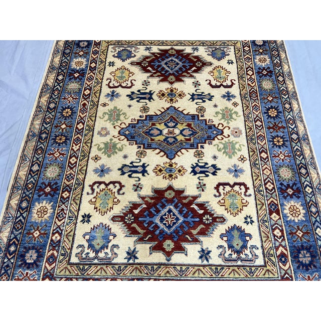 2000 - 2009 Ivory and Blue Kazak Wool Area Rug With Tribal Medallions, 4'10" X 6'7" For Sale - Image 5 of 15