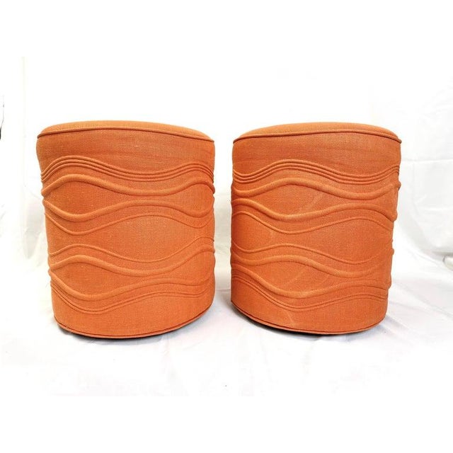 Pair of Cylindrical Swivel Ottomans in Orange , Fun textural design. In need of a recover. Dimensions: Height: 19.5 in...