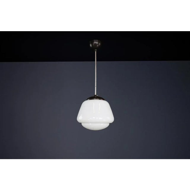 Bauhaus opaline & bakelite pendant lamp, czech republic 1950s this elegant pendant lamp, designed in the 1950s in czech...