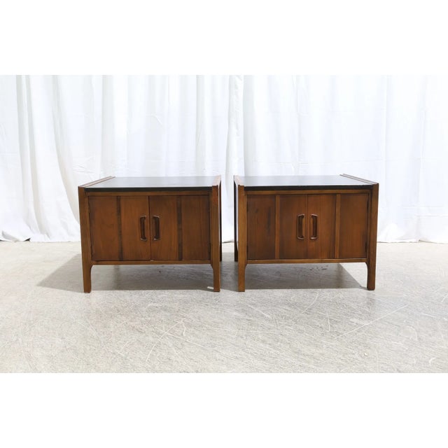 Offered is a stunning pair of mid-century modern nightstands manufactured in the 1960s. Crafted from rich walnut wood,...