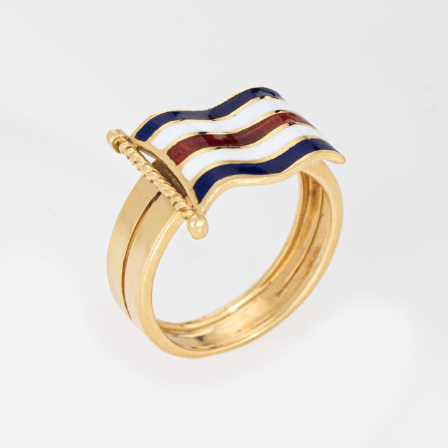 Stylish vintage nautical flag ring crafted in 18 karat yellow gold (circa 1970s). Rendered in vibrant red, white, and blue...