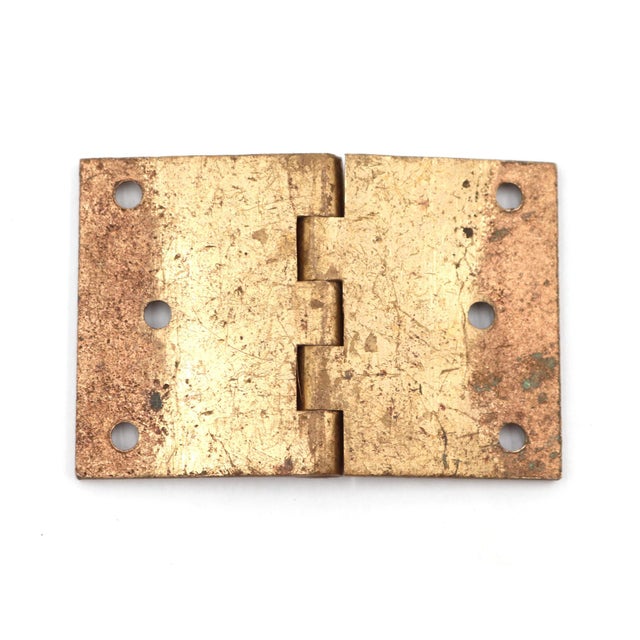 Vintage cabinet hinge made of polished brass with flat tips, five knuckles, and a template hole pattern. The original...