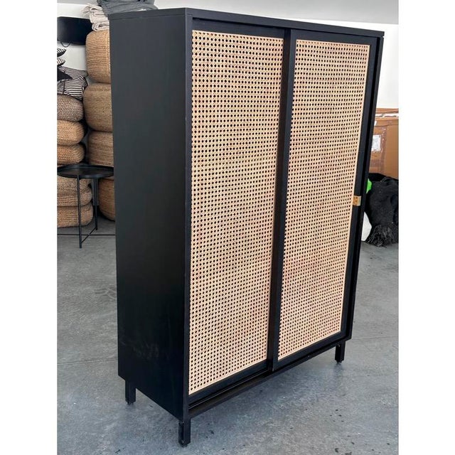 Children's wardrobe with sliding cane panels and 3 shelves on each side. Our young son loved this wardrobe as it is easy...