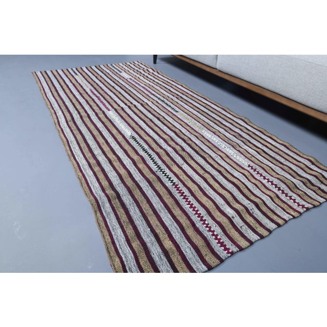 Vintage Turkish Hand-Knotted vintage rug is a semi-Vintage kilim runner rug.'70s Eastern region of Turkey's unique rug is...