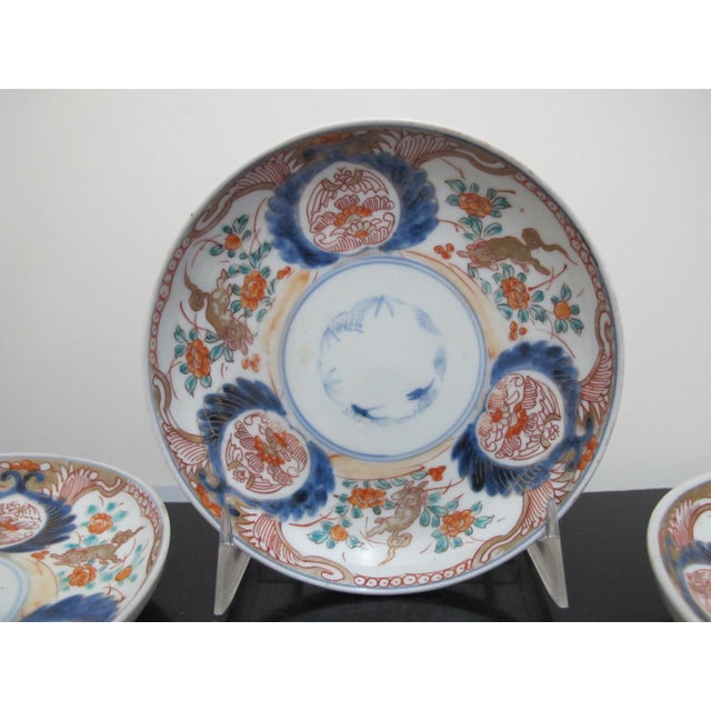 Sweet and lovely Japanese Imari porcelain small plate or shallow bowl set of 6. Each with a beautifully hand painted Kirin...