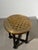 Characterful round side table featuring a copper top decorated with a chessboard pattern and intricate scrolling motifs....