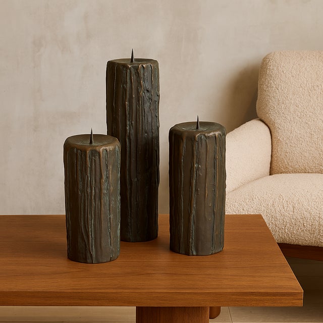 A dramatic trio of Mid-Century cast bronze candle sculptures, each crafted to resemble oversized, melting beeswax columns....