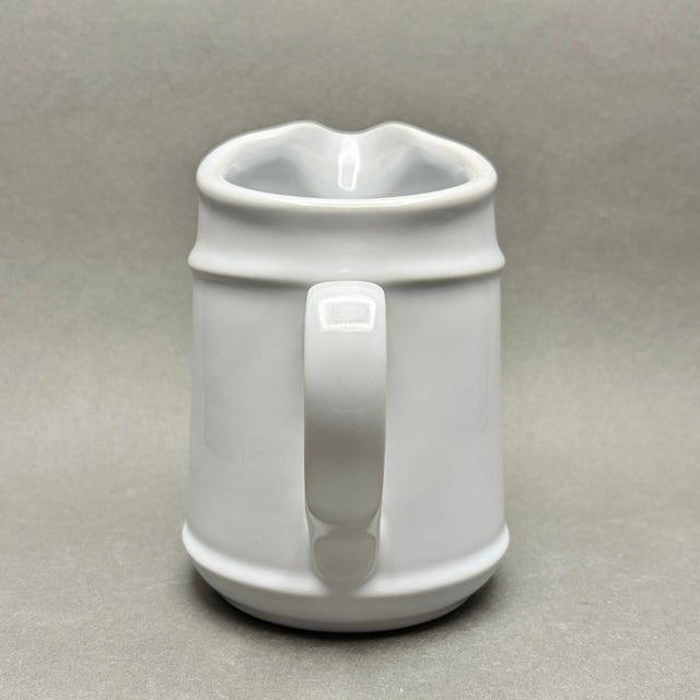 • This versatile ceramic pitcher seamlessly blends Mid-Century Modern minimalism with a classic farmhouse aesthetic,...