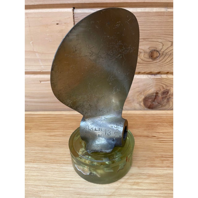 Unusual vintage nautical folk art piece created from the broken blade and hub of an authentic marine propeller, mounted...