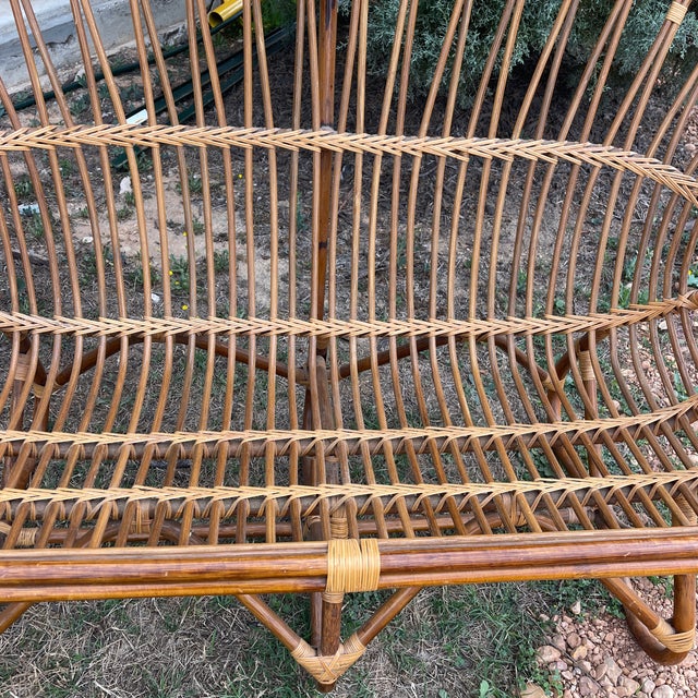 A vintage mid- century 1970’s rattan loveseat in the style of Franco Albini. The love seat has a great surface and is in...