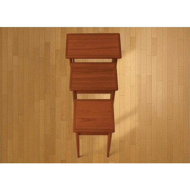 Set of three stackable side tables. The tables feature the classic tapered legs, a signature danish design element. They...