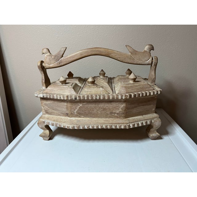 Teak wood with antique finish. Decorative footed display box to hold spices or tea. Tiny compartments with removable lids...