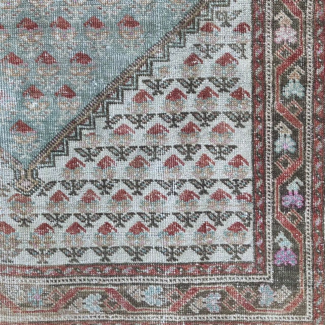An Antique Gördes Rug with Soft Florals and Subtle Color Handwoven approximately 100 years ago in the historic Gördes...