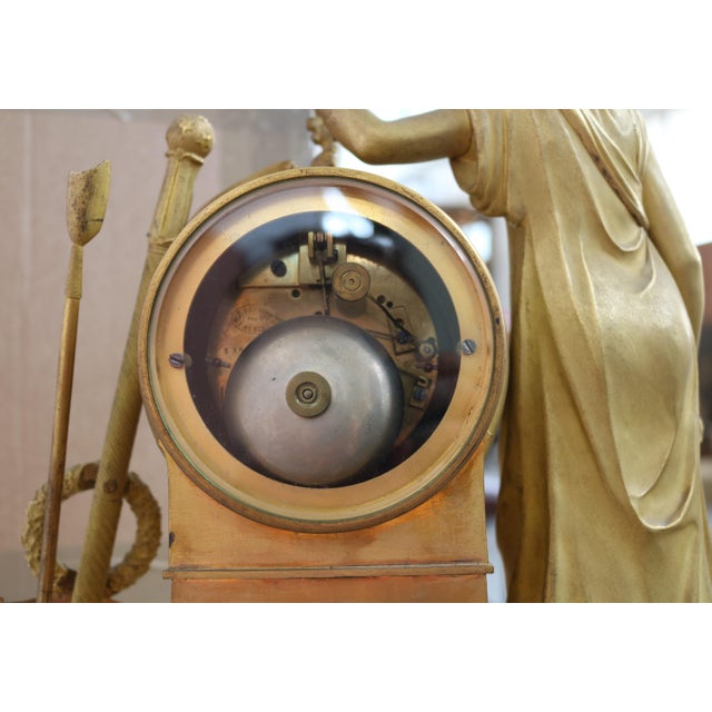 An important love-themed clock crafted from finely engraved gilded bronze. The movement is marked "E. Gautier and J....