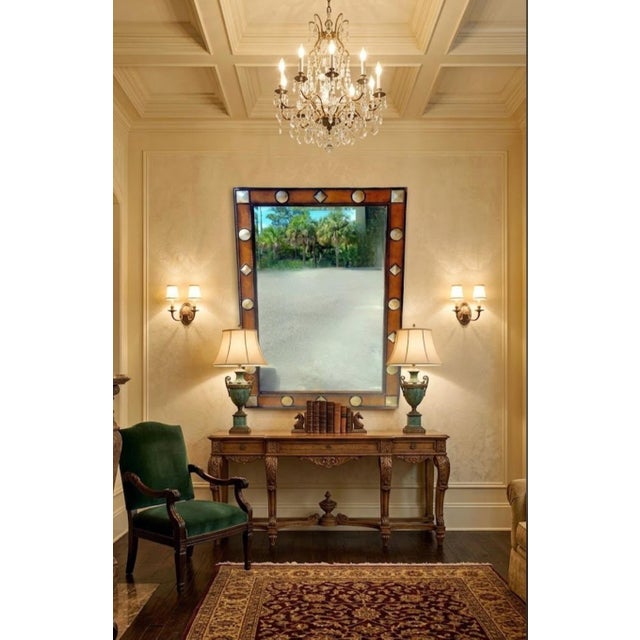 Make a striking, high-design statement with this large-scale wall mirror featuring a rich leather frame accented by...