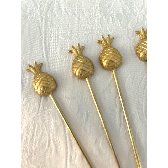 Stylish set of eight figural stainless steel pineapple design appetizer skewer forks in a gold finish.