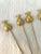 Stylish set of eight figural stainless steel pineapple design appetizer skewer forks in a gold finish.