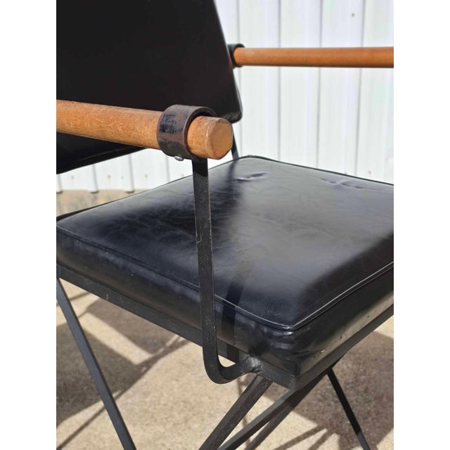 Pair of Cleo Baldon campaign style bar stools in bamboo, faux leather and wrought iron.
