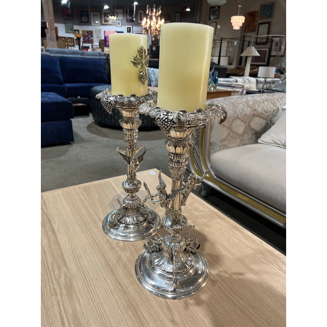 An exceptionally detailed pair of silver plated candle holders featuring dramatic Gothic-inspired design elements. Each...