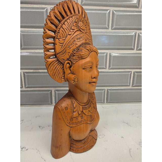 An exceptional, gallery-tier mid-century Balinese modernist portrait bust depicting a traditional ceremonial Legong...