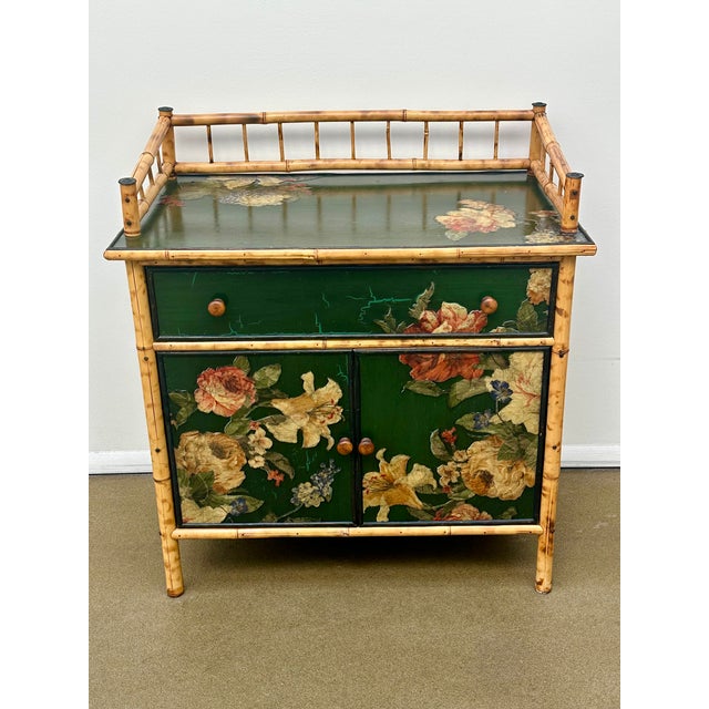 This cabinet is decorated with colorful flowers against dark green background. and “tortoise” style bamboo. It is very...