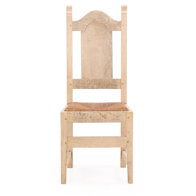 A stately and architectural set of six Belgian oak dining chairs from the 1960s, crafted from stripped wood with angular...