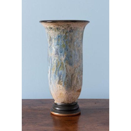 An early 20th-century glazed stoneware vase by Belgian ceramicist Roger Guérin (1896–1954). Of tall flared trumpet form...