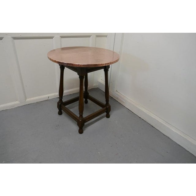 Copper topped tavern table or occasional table The table stands on turned oak legs with stretchers and has a traditional...