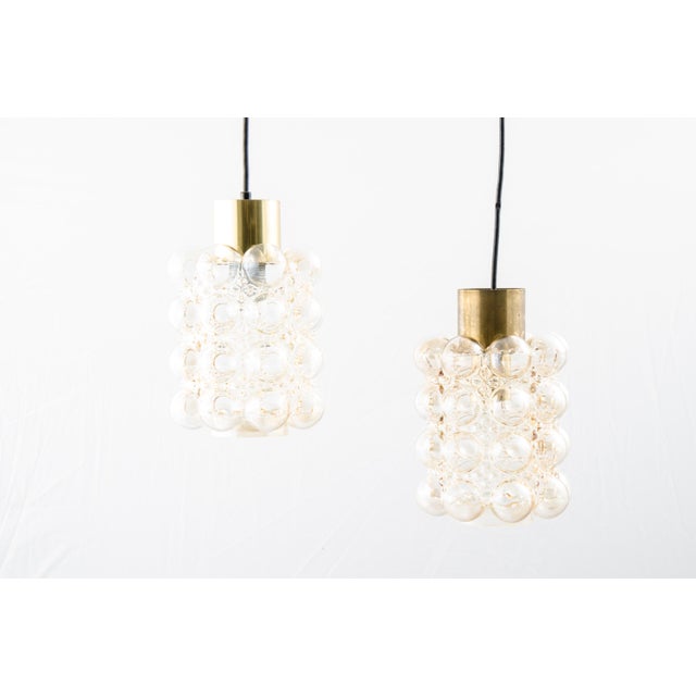 This pair of ceiling lamps by Helena Tynell and Heinrich Gantenbrink were manufactured by Glashütte Limburg in the 1960s....