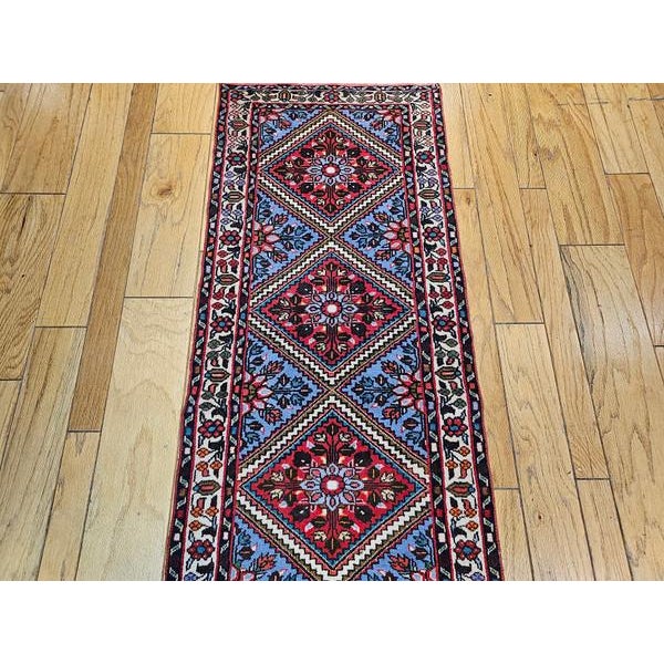 2’ 3” x 9’ 2” This handmade Persian runner has a combination of floral and geometric design consisting of six diamond...