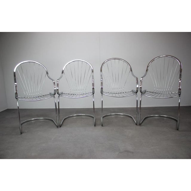 An elegant set of four chrome dining chairs attributed to renowned Italian designer Gastone Rinaldi, manufactured by RIMA,...