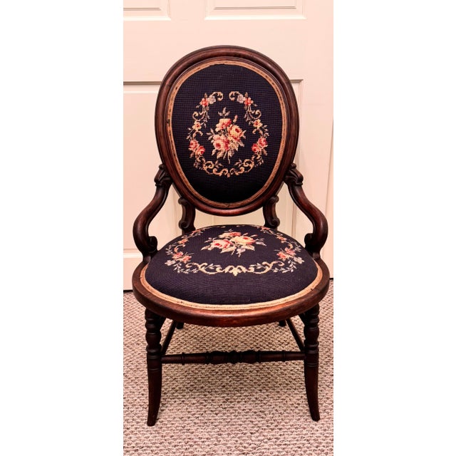 Beautiful antique-style armchair featuring an elegant oval back and classic curved wooden arms. The chair is upholstered...
