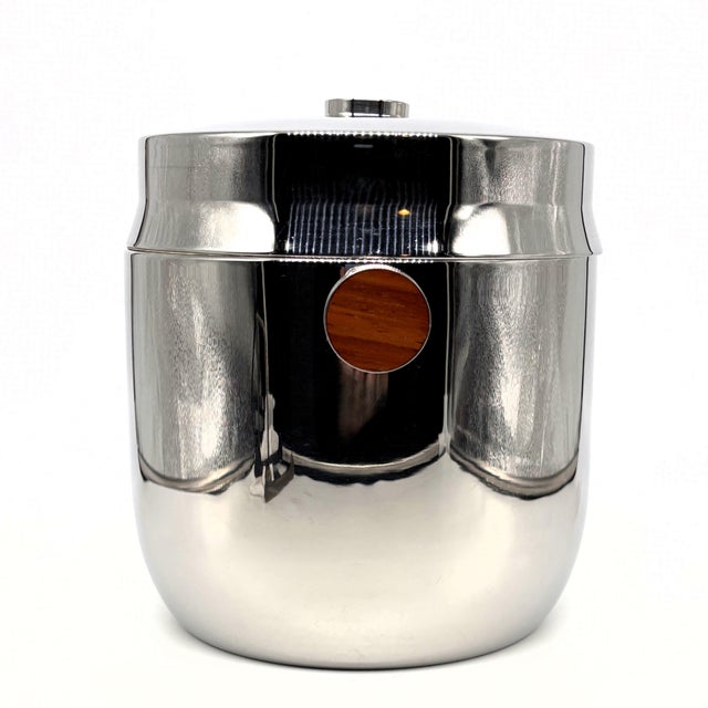 A refined mid-century modern ice bucket crafted from polished 18-8 stainless steel, produced for Hormel Corp as part of...
