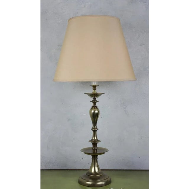 A handsome pair of American mid-century table lamps crafted in brass with a warm English brass finish. Their elegant...