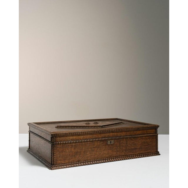 Made in France in the early 20th century, this oak box is finished in a deep brown patina that shows off the strong,...
